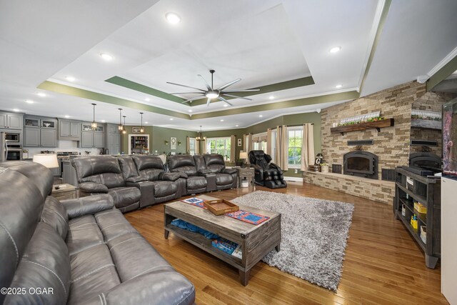 8740 County Road 241, Webb City, MO 64870 - living room featuring a raised ceiling, ceiling fan, ornamental molding, wood finished floors, and recessed lighting