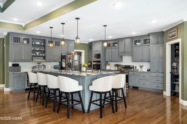 8740 County Road 241, Webb City, MO 64870 - kitchen featuring gray cabinets, appliances with stainless steel finishes, tasteful backsplash, crown molding, and a kitchen bar
