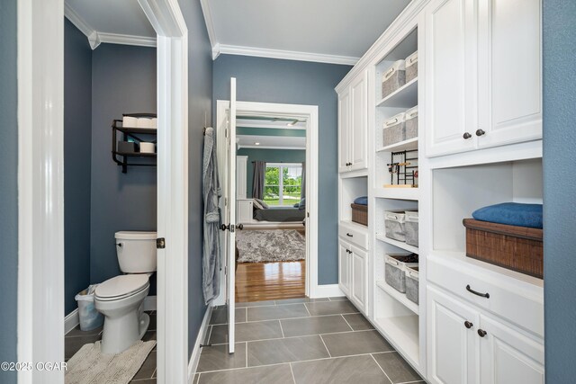 8740 County Road 241, Webb City, MO 64870 - bathroom with ornamental molding, tile patterned flooring, toilet, and baseboards