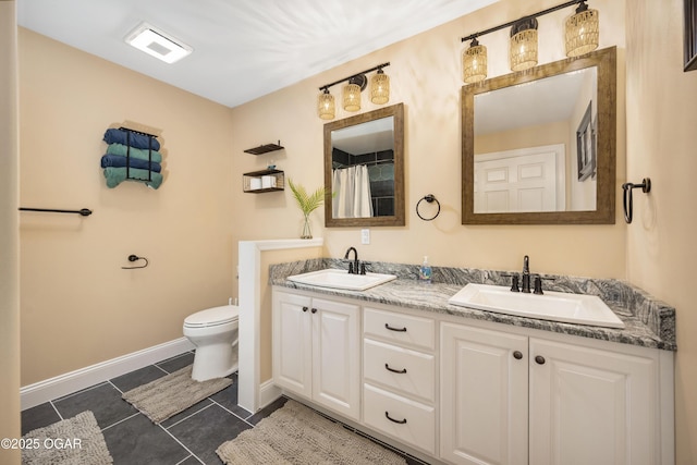 8740 County Road 241, Webb City, MO 64870 - bathroom with double vanity, toilet, tile patterned floors, and baseboards