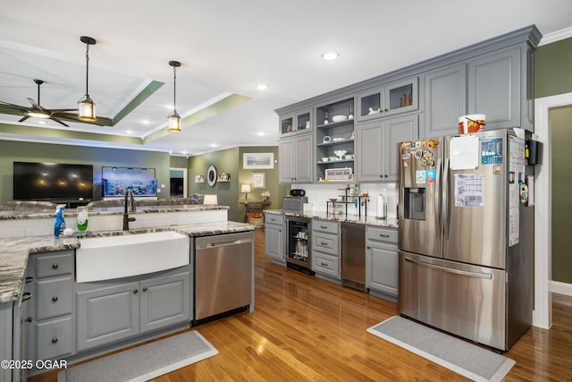 8740 County Road 241, Webb City, MO 64870 - kitchen with appliances with stainless steel finishes, gray cabinets, a sink, crown molding, and beverage cooler