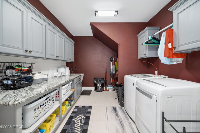 8740 County Road 241, Webb City, MO 64870 - laundry room featuring washer and dryer, cabinet space, light tile patterned floors, and baseboards