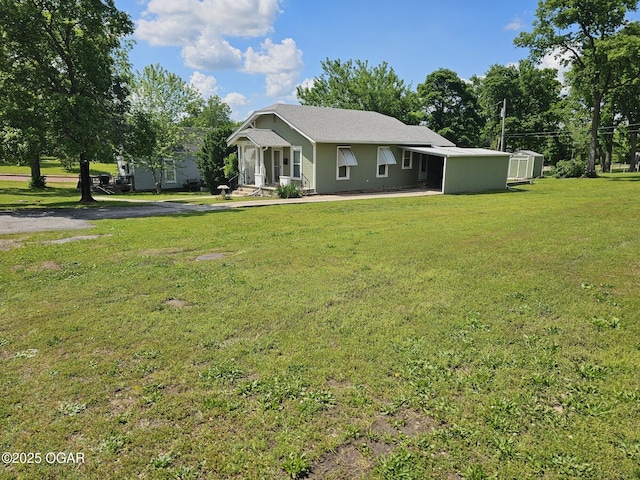 ranch-style house featuring a front yard, a shed, and an outdoor structure