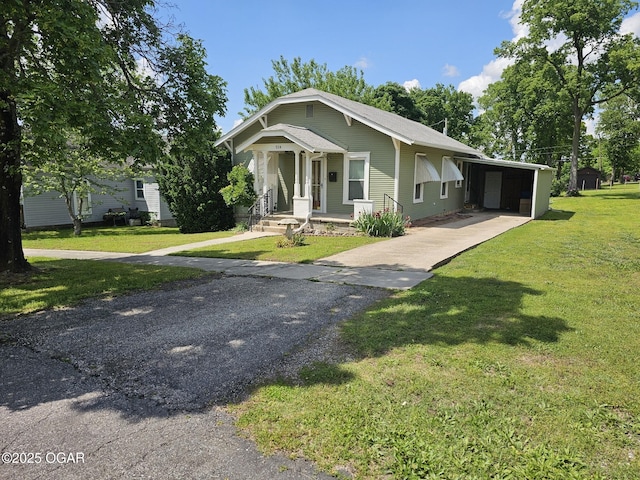 view of front of property with driveway, a front lawn, and a carport