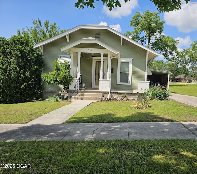 view of front of house featuring a front yard, a porch, and a carport