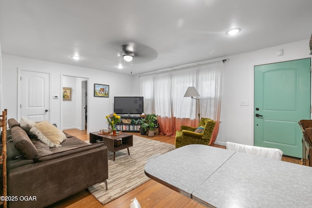 living room featuring a ceiling fan and wood finished floors
