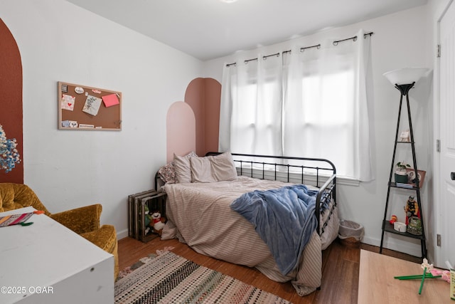 bedroom featuring wood finished floors and baseboards