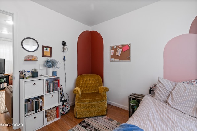 bedroom with wood finished floors and baseboards