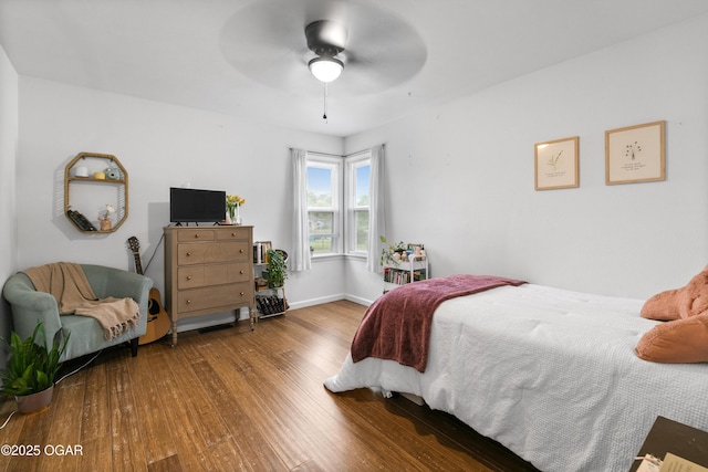 bedroom with wood finished floors, baseboards, and ceiling fan