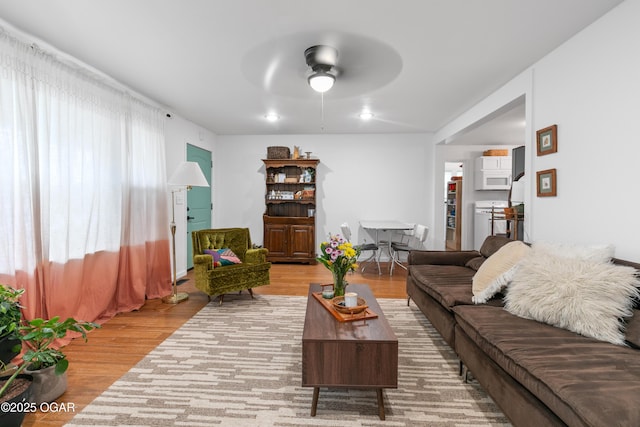 living area featuring ceiling fan and wood finished floors