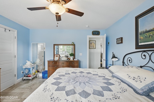 bedroom with a ceiling fan and baseboards