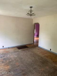 426 N Jackson Ave, Joplin, MO 64801 - unfurnished room with arched walkways, baseboards, and a chandelier