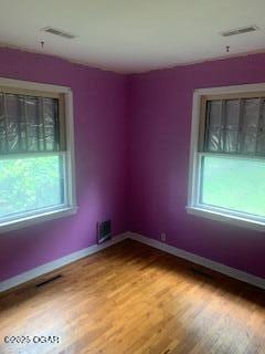426 N Jackson Ave, Joplin, MO 64801 - empty room featuring plenty of natural light, light wood-style flooring, and baseboards
