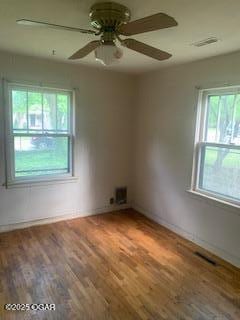 426 N Jackson Ave, Joplin, MO 64801 - empty room with wood finished floors, a ceiling fan, and baseboards