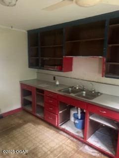 426 N Jackson Ave, Joplin, MO 64801 - bar featuring light floors, baseboards, and a sink