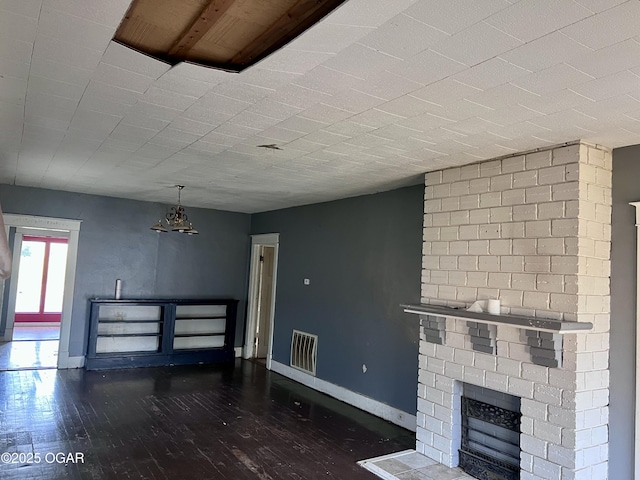 210 W 4th St, Webb City, MO 64870 - unfurnished living room featuring a fireplace and wood finished floors