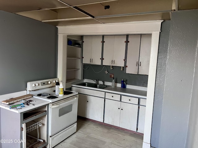 210 W 4th St, Webb City, MO 64870 - kitchen featuring white range with electric stovetop, light wood finished floors, light countertops, and open shelves