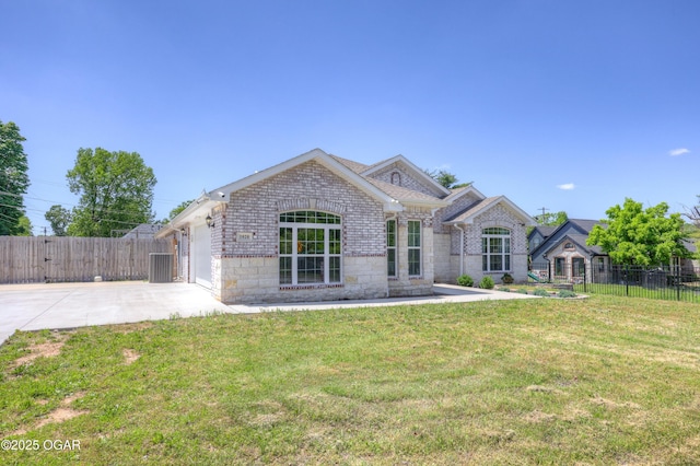 1020 S Florida Ave, Joplin, MO 64801 - view of front of property with concrete driveway, an attached garage, brick siding, and stone siding