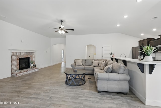 1020 S Florida Ave, Joplin, MO 64801 - living room with lofted ceiling, arched walkways, recessed lighting, a ceiling fan, and baseboards