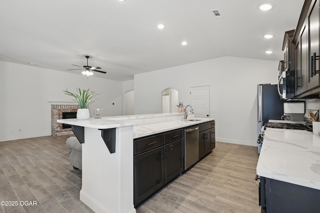 1020 S Florida Ave, Joplin, MO 64801 - kitchen with appliances with stainless steel finishes, ceiling fan, light wood-style floors, a kitchen island with sink, and a sink