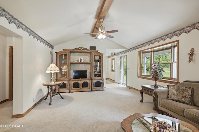 living area featuring carpet, baseboards, and ceiling fan