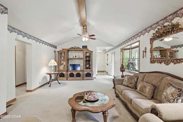 carpeted living area featuring ceiling fan and baseboards