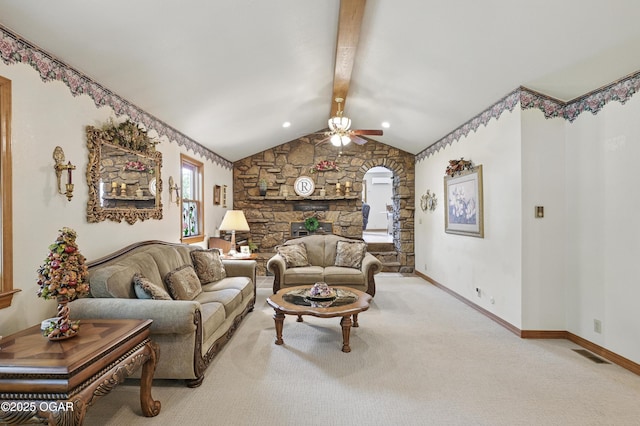 carpeted living area with ceiling fan and baseboards