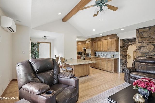 living area featuring a wall mounted AC, light wood-style floors, ceiling fan, recessed lighting, and baseboards