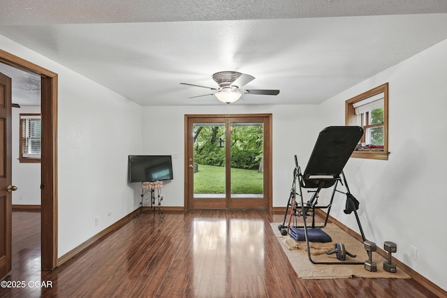 workout area with hardwood / wood-style floors, baseboards, and a ceiling fan
