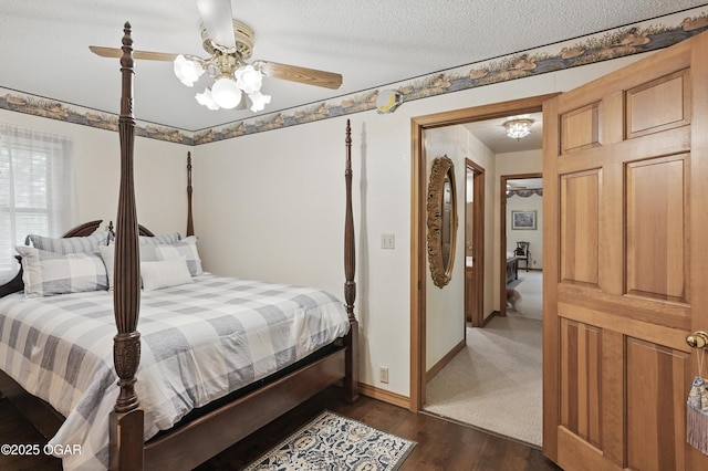 bedroom featuring dark wood-type flooring, baseboards, and ceiling fan