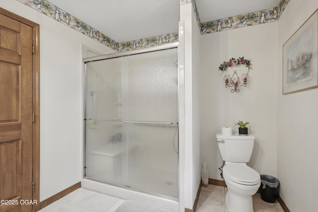 full bathroom with baseboards, a stall shower, toilet, and tile patterned flooring