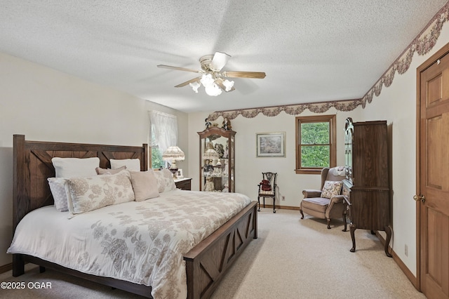 bedroom featuring light carpet, baseboards, a ceiling fan, and a textured ceiling