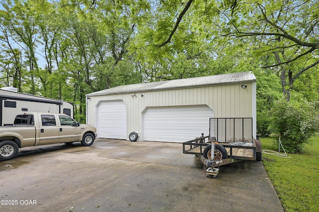 detached garage with view of scattered trees