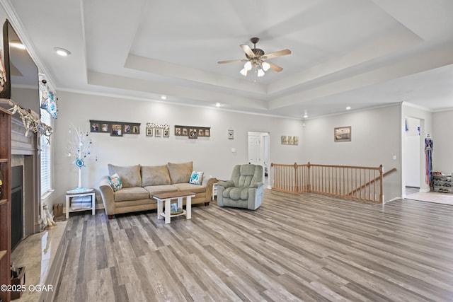 10208 Timberline Cir, Joplin, MO 64804 - living room with a raised ceiling, light wood finished floors, ceiling fan, and recessed lighting