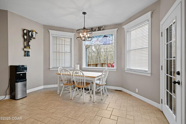 10208 Timberline Cir, Joplin, MO 64804 - dining room featuring a chandelier, plenty of natural light, and baseboards