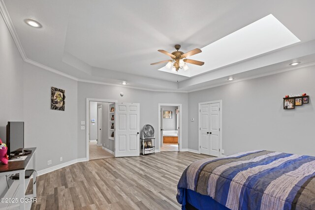 10208 Timberline Cir, Joplin, MO 64804 - bedroom featuring a raised ceiling, light wood finished floors, recessed lighting, baseboards, and ornamental molding