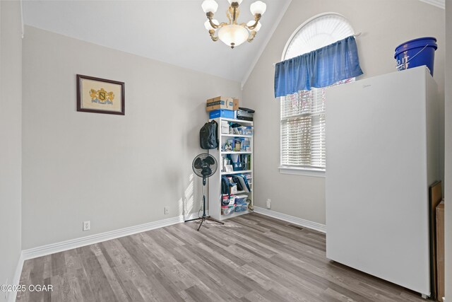 10208 Timberline Cir, Joplin, MO 64804 - interior space featuring vaulted ceiling, wood finished floors, a chandelier, and baseboards