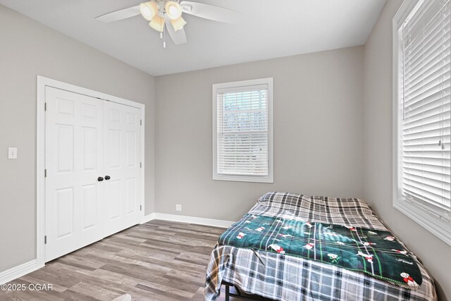 10208 Timberline Cir, Joplin, MO 64804 - bedroom featuring wood finished floors, baseboards, a closet, and ceiling fan