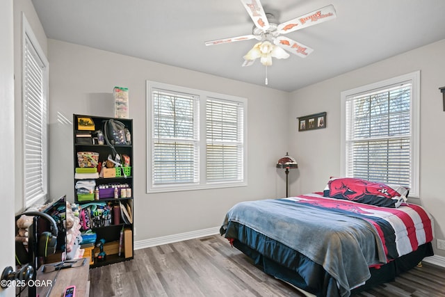 10208 Timberline Cir, Joplin, MO 64804 - bedroom with baseboards, wood finished floors, and a ceiling fan