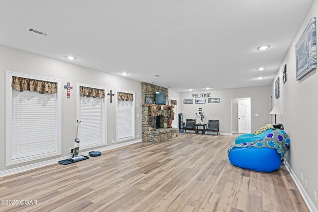 10208 Timberline Cir, Joplin, MO 64804 - workout area featuring a fireplace, light wood-style floors, recessed lighting, and baseboards