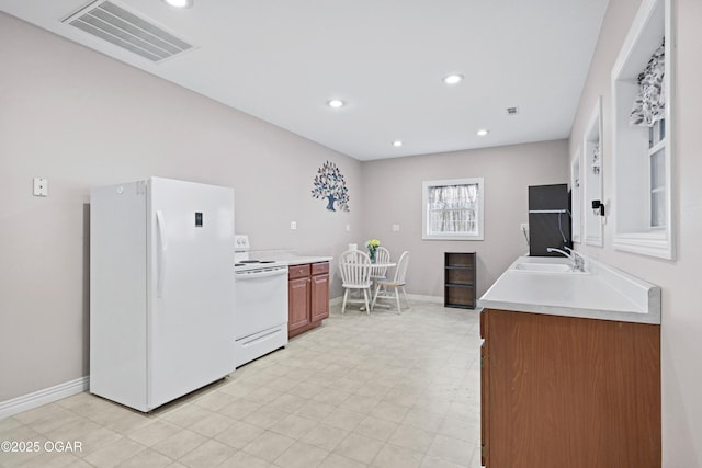 10208 Timberline Cir, Joplin, MO 64804 - kitchen featuring white appliances, a sink, light countertops, baseboards, and recessed lighting