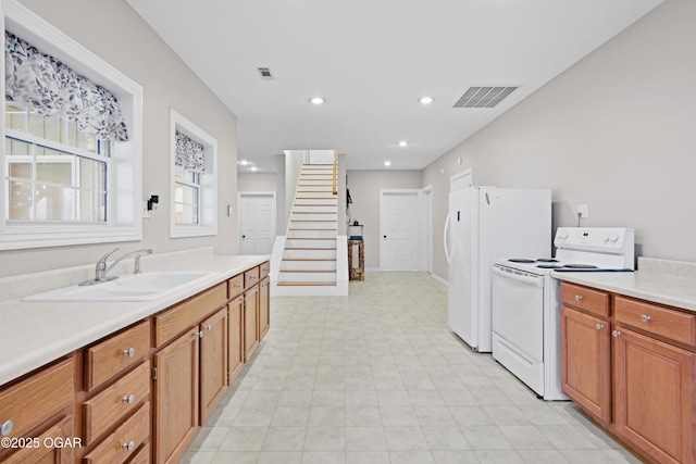 10208 Timberline Cir, Joplin, MO 64804 - kitchen with white electric range, a sink, light countertops, brown cabinets, and recessed lighting