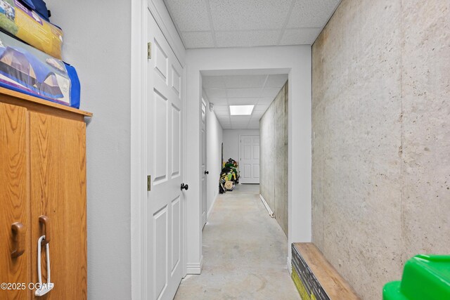 10208 Timberline Cir, Joplin, MO 64804 - hallway featuring a paneled ceiling and concrete floors
