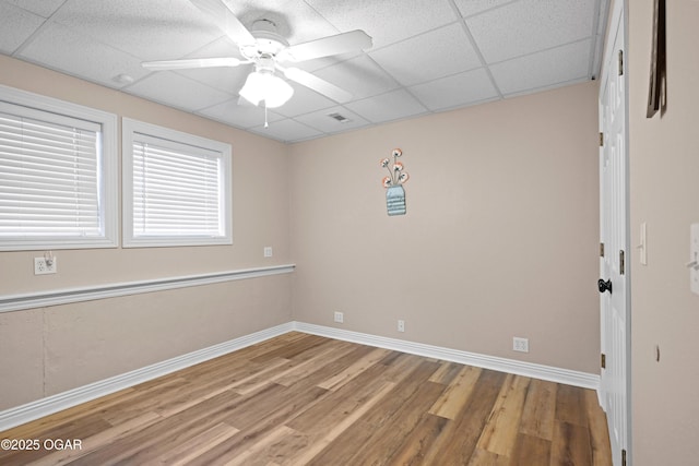 10208 Timberline Cir, Joplin, MO 64804 - empty room with wood finished floors, a paneled ceiling, baseboards, and ceiling fan