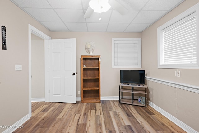 10208 Timberline Cir, Joplin, MO 64804 - interior space with wood finished floors, a ceiling fan, a paneled ceiling, and baseboards