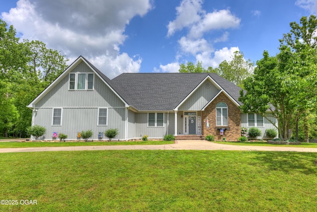 10208 Timberline Cir, Joplin, MO 64804 - view of front of house with a shingled roof, a front lawn, brick siding, and board and batten siding