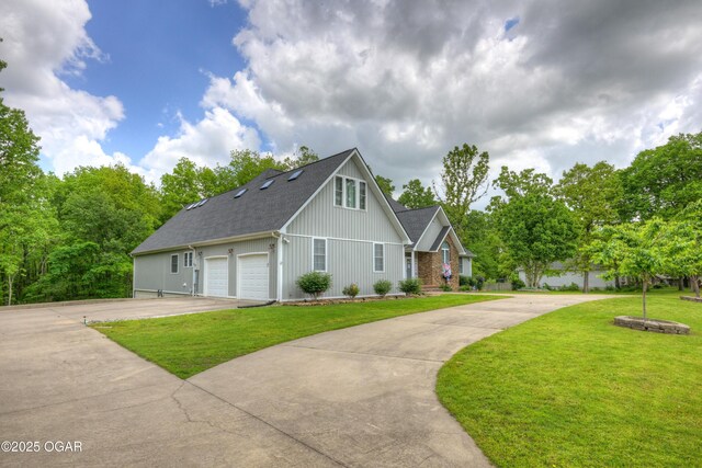 10208 Timberline Cir, Joplin, MO 64804 - view of front of house with concrete driveway, board and batten siding, and a front lawn