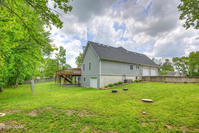 10208 Timberline Cir, Joplin, MO 64804 - rear view of property featuring a wooden deck, a garage, stairs, central AC unit, and roof with shingles