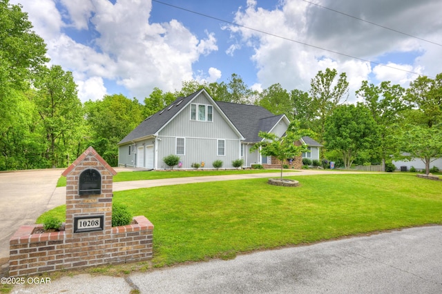 10208 Timberline Cir, Joplin, MO 64804 - view of front facade featuring board and batten siding, a garage, a front lawn, and driveway