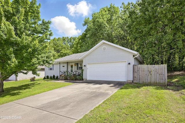 ranch-style house featuring an attached garage, driveway, and covered porch